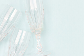 Crystal glasses on a blue background. Minimal composition with copy space.