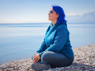 Female wearing light blue oversize hoodie and jeans