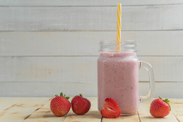 Fresh milkshake with strawberries. A glass of fresh strawberry milkshake