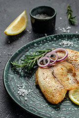 Baked white fish fillet tilapia or pangasius. vertical image. top view. place for text