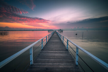 Wooden jetty on the sea at beautiful sunset, Indonesia - 615433025