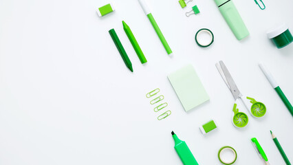 Set of green stationery for work and study on white background. Back to school. Top view, flat lay, copy space