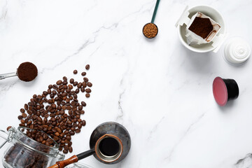 Ingredients for making coffee. Different ways to make coffee metal cezve, coffee machine capsules, drip. Coffee making concept. Flat Lay. Top view. Copy space