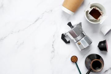 Ingredients for making coffee. Different ways to make coffee geyser moka maker,  metal cezve, coffee machine capsules, drip. Coffee making concept. Flat Lay. Top view. Copy space