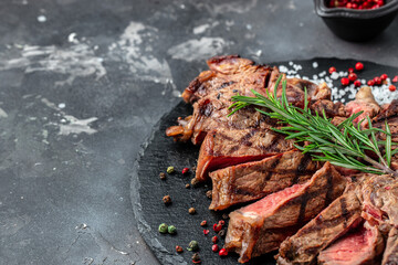 Grilled beef steak medium rare on a dark background. Long banner format. top view