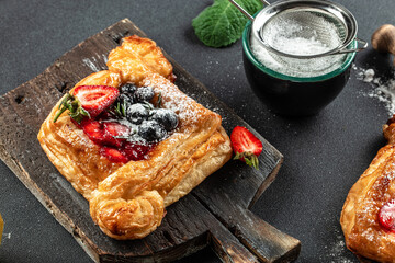 Fresh delicious puff pastry with sweet berries, Food recipe background. Close up