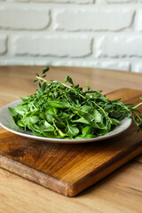 Green basil on a wooden kitchen board