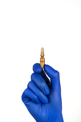 Hand in blue glove holding ampoule isolated on white background.