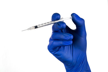 Syringe in hand in blue glove isolated on a white background.