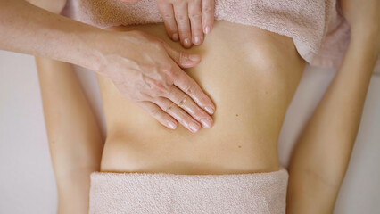 Fototapeta na wymiar Calming and Rejuvenating Massage for Women Stomach Top View