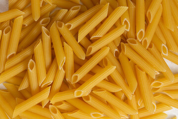 Italian pasta on table with tomatoes, pepper and different species