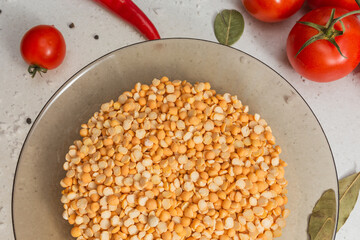 Italian pasta on table with tomatoes, pepper and different species