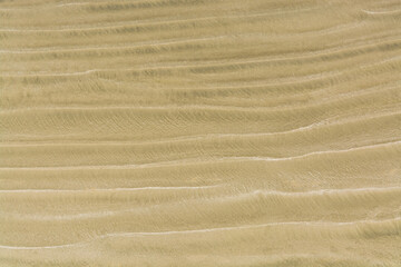 Fototapeta na wymiar Waves of sand on one of Pacific ocean beaches