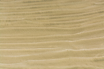 Waves of sand on one of Pacific ocean beaches