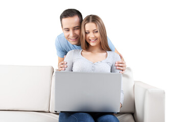 Smiling Couple Using Laptop on the Couch