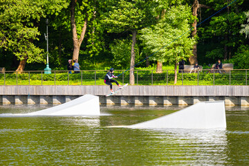 Moscow, Russia - June 02, 2023: girl wakeboarding in the park.