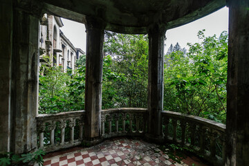 Fototapeta premium Old overgrown balcony in old abandoned mansion