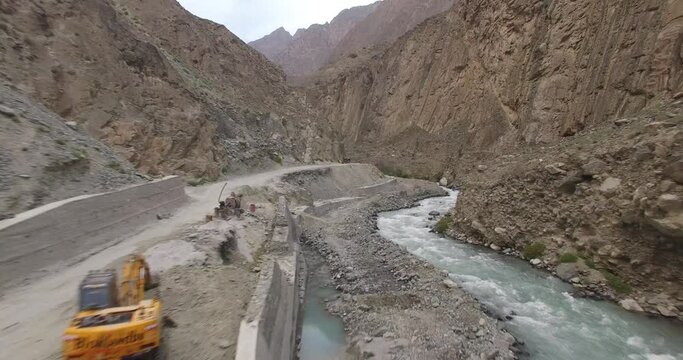 4k shot of dam in the mountains drone shot of river and dam in hunza, gilgit baltistan Pakistan high angle view 