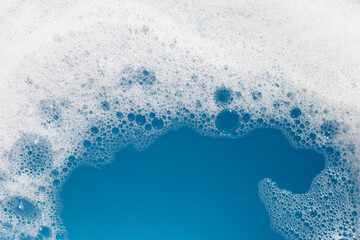 Detergent foam bubble on water. Blue background, Soap sud