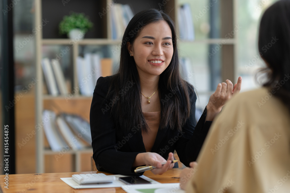 Wall mural confident, friendly, two asian businesswoman discuss new startup projects, present projects, ideas, 