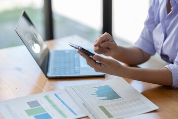 Confident businesswoman working using mobile phone to search for information Talk through an application about financial investments in real estate business projects. management system concept.