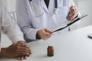 The doctor and the patient are discussing the details of the treatment, the results of the physical examination of the patient. Annual physical examination concept.