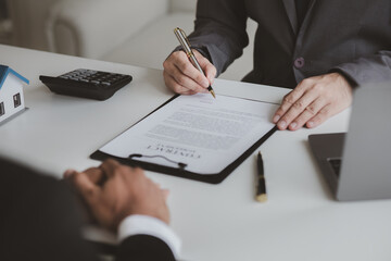 Real estate agents explain models of housing estates in projects to elaborate to clients, explaining and presenting information about homes and purchasing loans. Real estate trading concept.