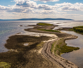 Fototapeta na wymiar Aerial shot of prominent cliff in Salthill, Galway Bay. Walkable during low tide, offering stunning views of County Clare. Picture-perfect location