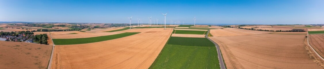 Panoramic aerial view of grain fields in the Palatinate near Biedesheim/Germany with wind turbines in the background