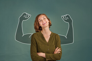 Portrait of young happy woman looking at camera and showing muscles. success concept.
