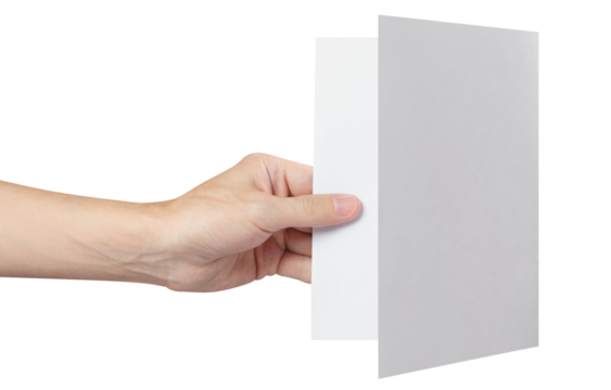 Hand holding a sheet of white paper, folded in half, cut out