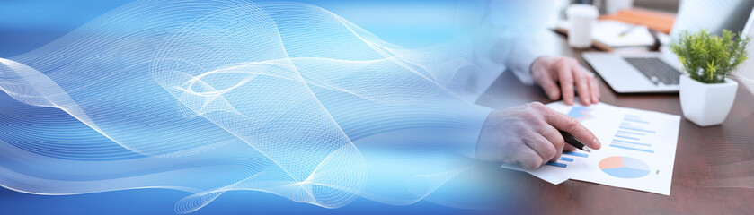 Businessman analysing marketing graphs; panoramic banner
