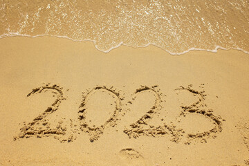 Child, playing on the beach in the sand, enjoying summer, number sign