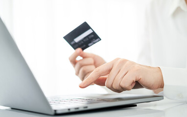 Payment online. Woman holding credit card and using laptop at home. Businessman working on computer in office. Business, e-commerce, internet banking, finance, online shopping, freelance concept