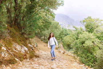 woman travels through the mountain gorge of Crete on a sunny summer day. banner, Crete / Greece
