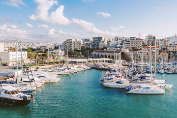 Crete, Greece - May 01, 2019: Yachts and ferry boat in the port of Heraklion. Panoramic and top view. Island of Crete, Greece