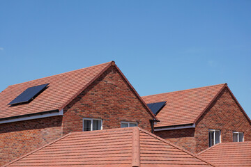 New homes with solar panels on rooftop. Residential housing estate using renewable energy source.  © Paul Cartwright