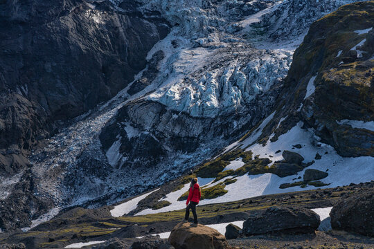 Woman exploring the area of Eyjafjallaj&ouml;kull which was the site of the famous volcanic eruption along Iceland's South Coast; Hella, South Iceland, Iceland