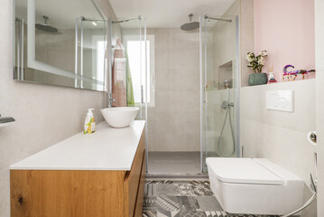 Bathroom with white resin sink on wooden furniture