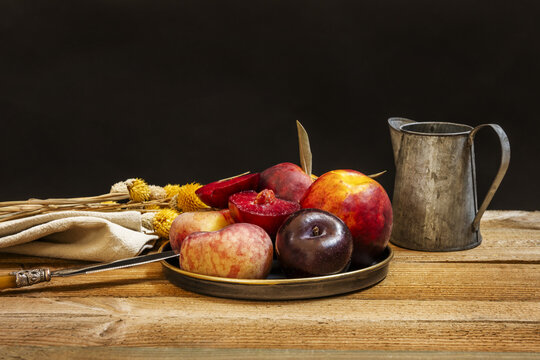 Still life with nectarines, paraguayas and ripe plums