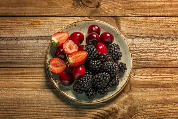 a small berry dish with ripe blackberries