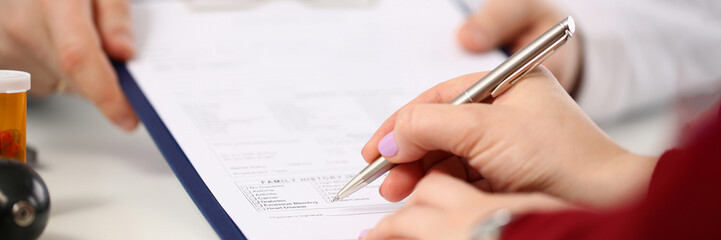 Doctor shows patient tablet with documents in clinic closeup. Signing and concluding medical contract and insurance