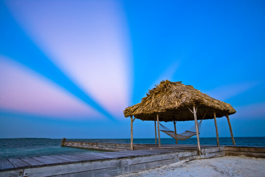 Hammock under a shelter at a resort on Turneffe Island; Turneffe Island, Belize