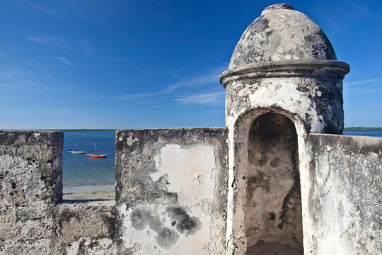 Two boats seen through a cut in an old stone wall; Ibo, Quirimbas Archipelago, Mozambique