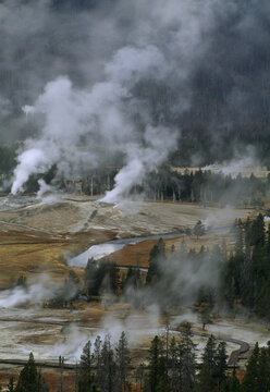 Steam rises from geothermal hot springs and geysers in Yellowstone National Park; United States of America