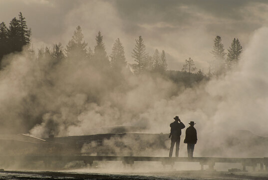 Tourists in geothermal steam and fog near the Upper Geyser Basin, Yellowstone National Park, USA; Wyoming, United States of America