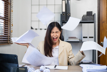 Asian businesswoman angry throwing papers over the herself in office when job fail, unsuccessful...