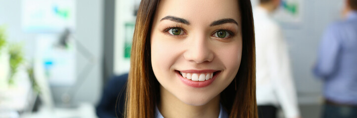 Portrait of beautiful joyful emotionally happy businesswoman in background of business colleague. Successful leadership career and internship in office