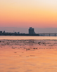 Вeautiful sunset near the river, turning into the night, view of the city of Dnipro
