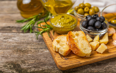 Italian ciabatta bread with olives, garlic, parmesan and rosemary on texture wooden background. Tasty food. Aperitif. Place for text. copy space. Delicacy. Bon appetit.